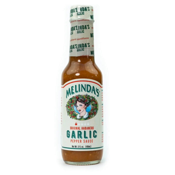 Melinda’s Garlic Habanero je kanček pekoča česnova omaka s habanero čiliji, narejena iz svežih sestavin, idealna za pico, testenine in vse, kar potrebuje dodatno česnovo aromo.